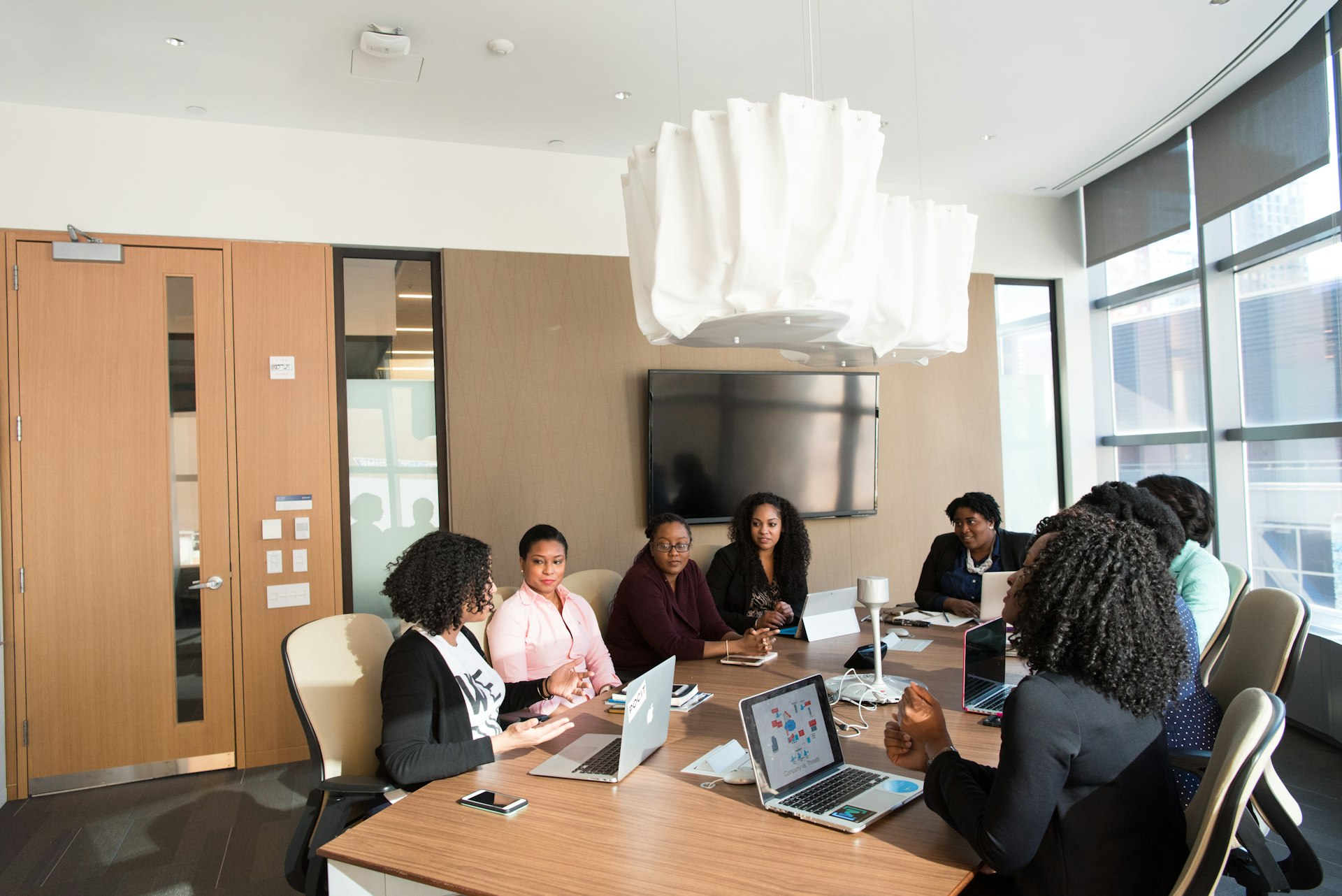 Diverse team of business professionals in a modern boardroom meeting